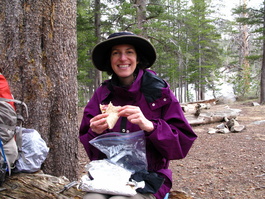 Lori munches salami and cheese at Upper
                            Twin Lake—yum!