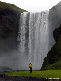 Lori in front of the Skógafoss waterfall