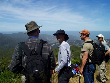Peter chats with Milon while Tim and David check out Montara Mountain (Pacifica in the background)
