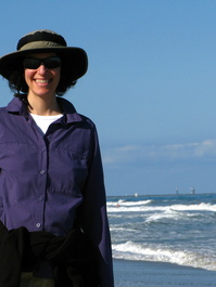Lori on the beach with the Delta II and
                       Kepler beyond