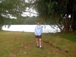 Lori in front of the cove behind the hotel and trees with interesting roots