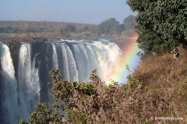 Tourists enjoy the ever-present rainbows at the Victoria Falls