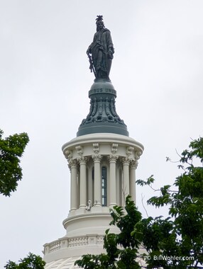 The Statue of Freedom by Thomas Crawford over the Capitol dome (1863)