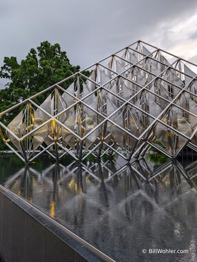 A metal and acrylic sculpture/mobile next to the Smithsonian National Air and Space Museum