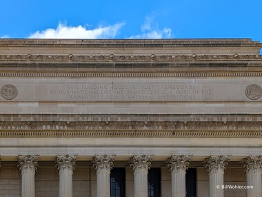 The National Archives building, the most ornate in the Federal Triangle, was completed in 1937; the inscription on the eastern side reads "This building holds in trust the records of our national life and symbolizes our faith in the permanency of our national institutions"