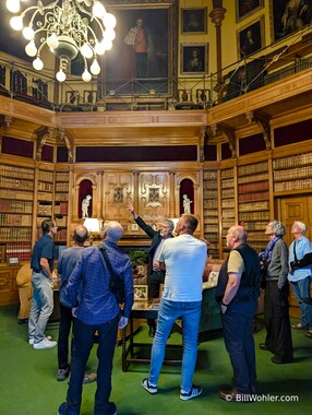 Peter Pennington points out the portraits in the library