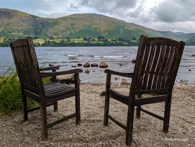 A pair of chairs overlook the Ullswater, although the chair on the right is missing something...something