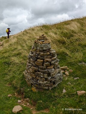 Lori walks past the first pile of rocks on the way to the Nine Standards