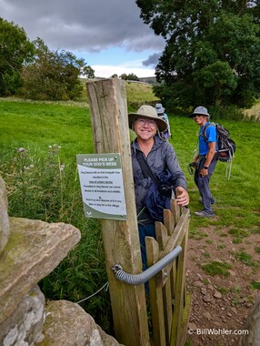 Dan holds the gate open for me while I read the sign that says that dog feces can cause illness and death in the sheep