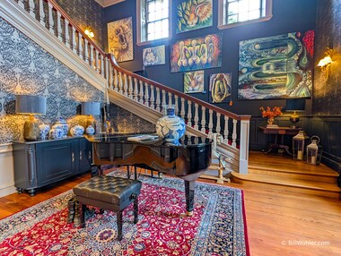 A grand piano in the stairwell's landing