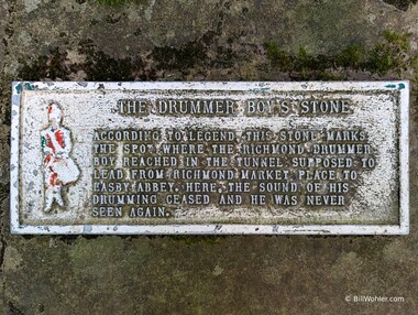 The plaque for the Drummer Boy's Stone marks the spot where the drumming ceased from a drummer boy exploring the tunnel from Richmond to Easby Abbey in the late 18th century