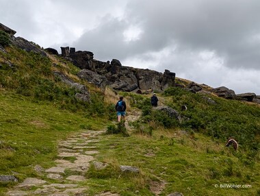 A passerby climbs up to the Wainstones