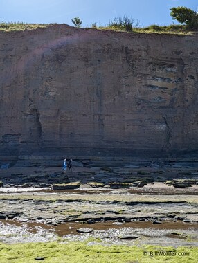 Steve and Lori stroll under the tall cliffs