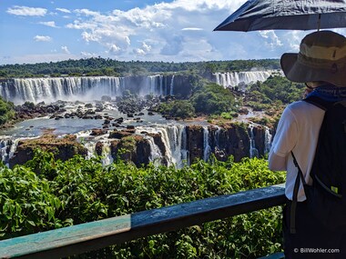 Lori takes in the impressive Iguazu Falls from the Brazil side while sheltering from the heat under an umbrella