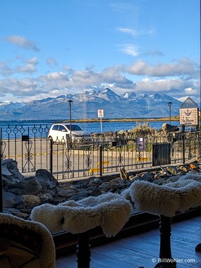 Tractor seats with sheepskin covers face the Chilean mountains across the Beagle Channel