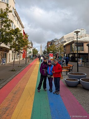 Lori, Sherry, and Dan pose on the rainbow street leading to the Hallgr&iacute;mskirkja (https://en.wikipedia.org/wiki/Hallgr%C3%ADmskirkja) in Reykjavik