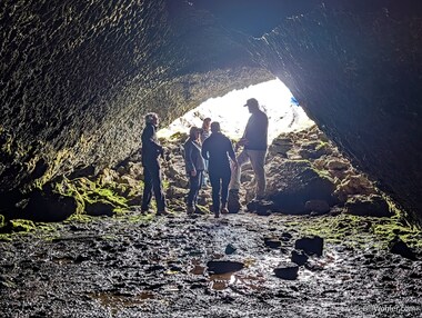 The conversation continues as the group exits the lava tube