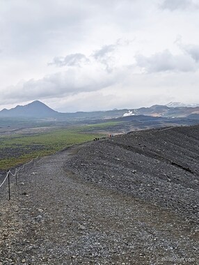 Our gang hikes along the rim of the Hverfjall Crater with views of the Bjarnarflag Geothermal Power Station power plant in the distance