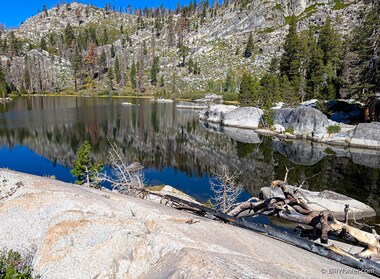 The granite mountains reflect off of the lake