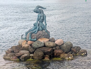 Further along the shore, a more abstract version called The Genetically Modified Little Mermaid, made by Bj&oslash;rn N&oslash;rgaard in 2000, can be found.