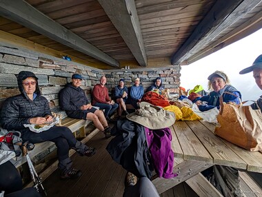Donna, Mats, Larry, Toby, Ron, Stefano, Jobie, and Dan take shelter from the rain in this hut called Egilbu and enjoy the massive lunches that the hotel prepared.