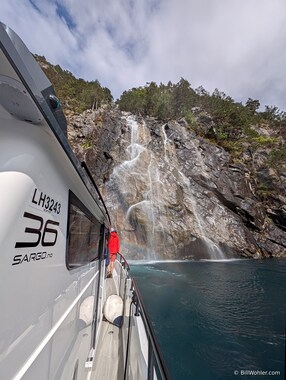 &Oslash;ystein edges the bow of his boat under this waterfall so that a few brave souls can take a shower.