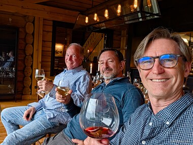 Dan, Ron, and Bill watch the rain after dinner while savoring their wine.